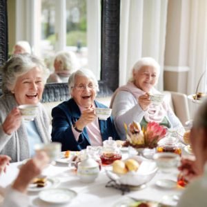 Cropped shot of a group of seniors having tea in their retirement home Cropped shot of a group of seniors having tea in their retirement home